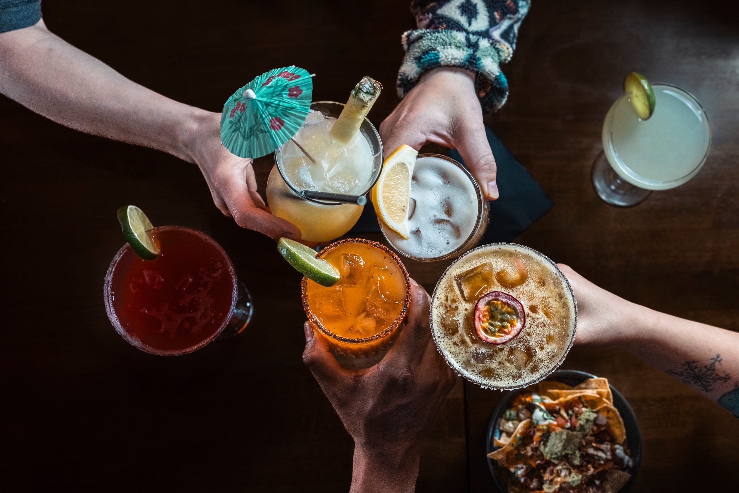 Friends toasting cocktails at Gringos
